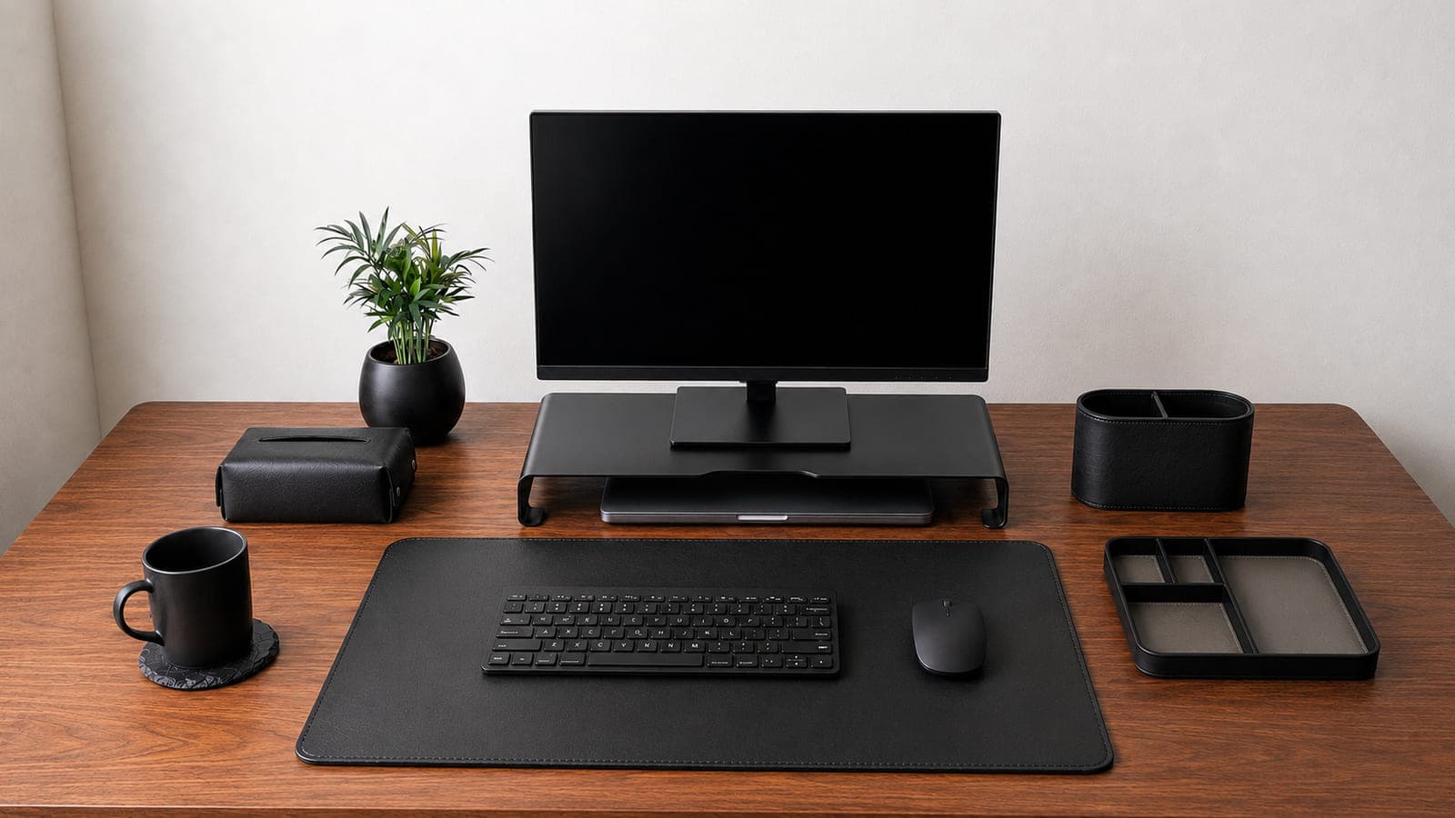 A walnut desk arranged with the full Well Ordered Studio collection